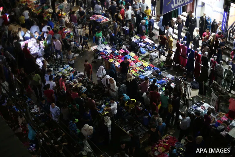 Palestinians shop at a market ahead of Eid al-Fitr holiday, in Gaza city on June 24, 2017. Eid al-Fitr marks the end of Muslim's holy fasting month of Ramadan when faithfuls abstain from eating, drinking, smoking and sex...