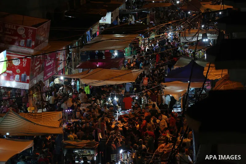 Palestinians shop at a market ahead of Eid al-Fitr holiday, in Gaza city on June 24, 2017. Eid al-Fitr marks the end of Muslim's holy fasting month of Ramadan when faithfuls abstain from eating, drinking, smoking and sex...