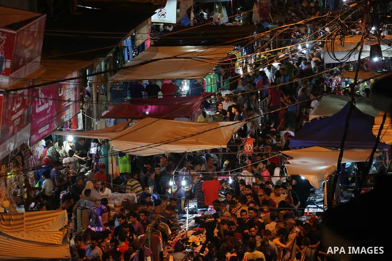 Palestinians shop at a market ahead of Eid al-Fitr holiday, in Gaza city on June 24, 2017. Eid al-Fitr marks the end of Muslim's holy fasting month of Ramadan when faithfuls abstain from eating, drinking, smoking and sex...
