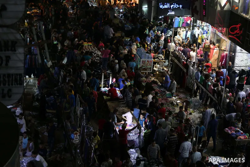 Palestinians shop at a market ahead of Eid al-Fitr holiday, in Gaza city on June 24, 2017. Eid al-Fitr marks the end of Muslim's holy fasting month of Ramadan when faithfuls abstain from eating, drinking, smoking and sex...