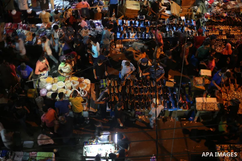 Palestinians shop at a market ahead of Eid al-Fitr holiday, in Gaza city on June 24, 2017. Eid al-Fitr marks the end of Muslim's holy fasting month of Ramadan when faithfuls abstain from eating, drinking, smoking and sex...
