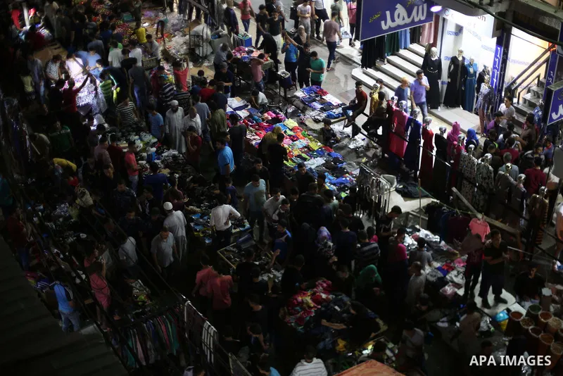 Palestinians shop at a market ahead of Eid al-Fitr holiday, in Gaza city on June 24, 2017. Eid al-Fitr marks the end of Muslim's holy fasting month of Ramadan when faithfuls abstain from eating, drinking, smoking and sex...