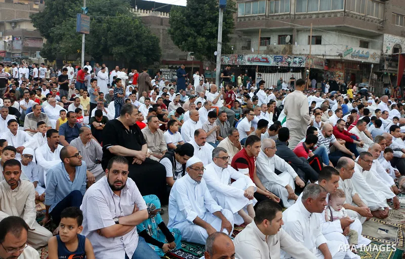Egyptians attend the morning prayers for Eid al-Fitr celebrations, which marks the end of the holy fasting month of Ramadan, in Cairo, Egypt, on June 25, 2017. Photo by Amr Sayed