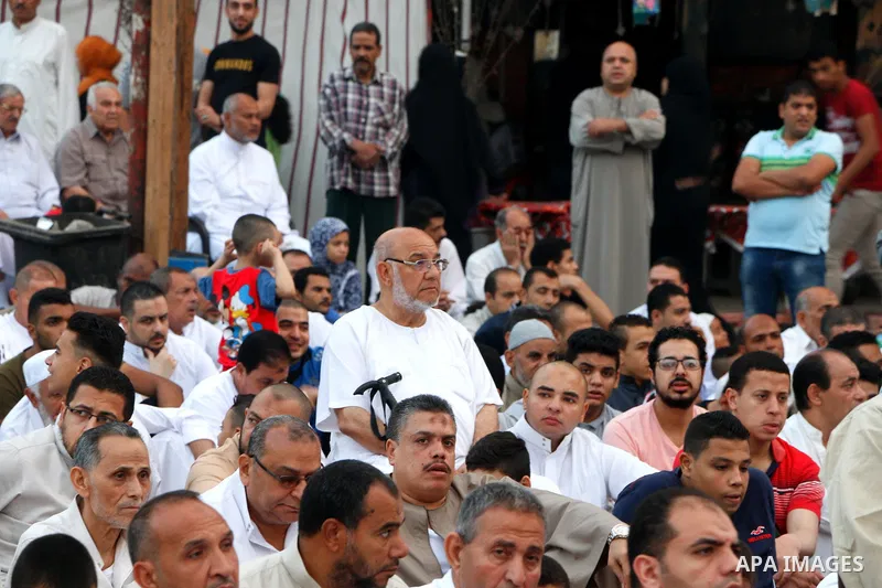 Egyptians attend the morning prayers for Eid al-Fitr celebrations, which marks the end of the holy fasting month of Ramadan, in Cairo, Egypt, on June 25, 2017. Photo by Amr Sayed