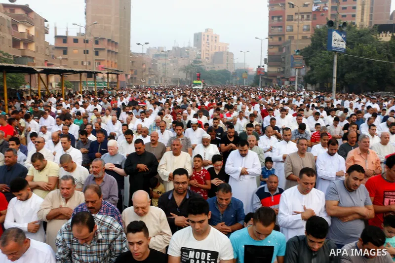 Egyptians attend the morning prayers for Eid al-Fitr celebrations, which marks the end of the holy fasting month of Ramadan, in Cairo, Egypt, on June 25, 2017. Photo by Amr Sayed