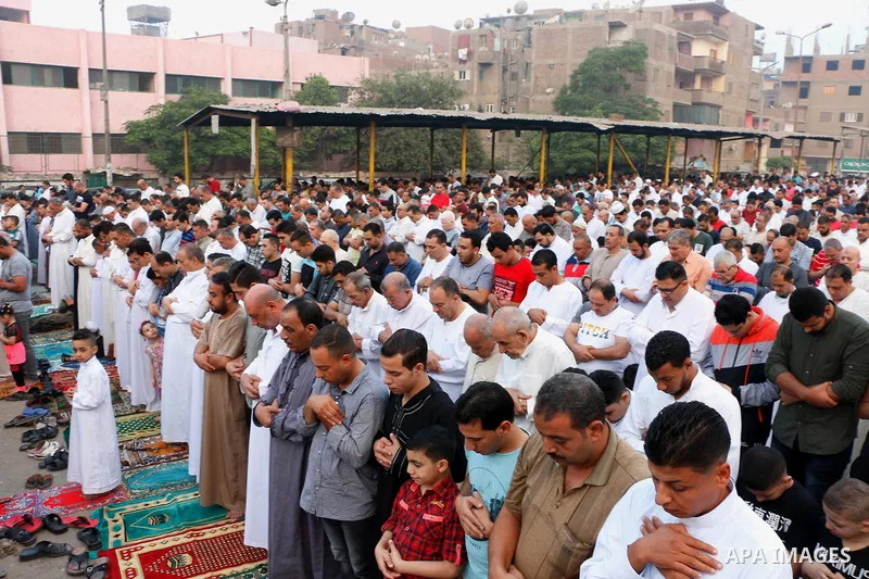 Egyptians attend the morning prayers for Eid al-Fitr celebrations, which marks the end of the holy fasting month of Ramadan, in Cairo, Egypt, on June 25, 2017. Photo by Amr Sayed