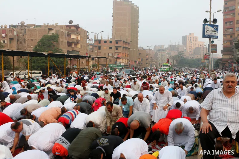 Egyptians attend the morning prayers for Eid al-Fitr celebrations, which marks the end of the holy fasting month of Ramadan, in Cairo, Egypt, on June 25, 2017. Photo by Amr Sayed