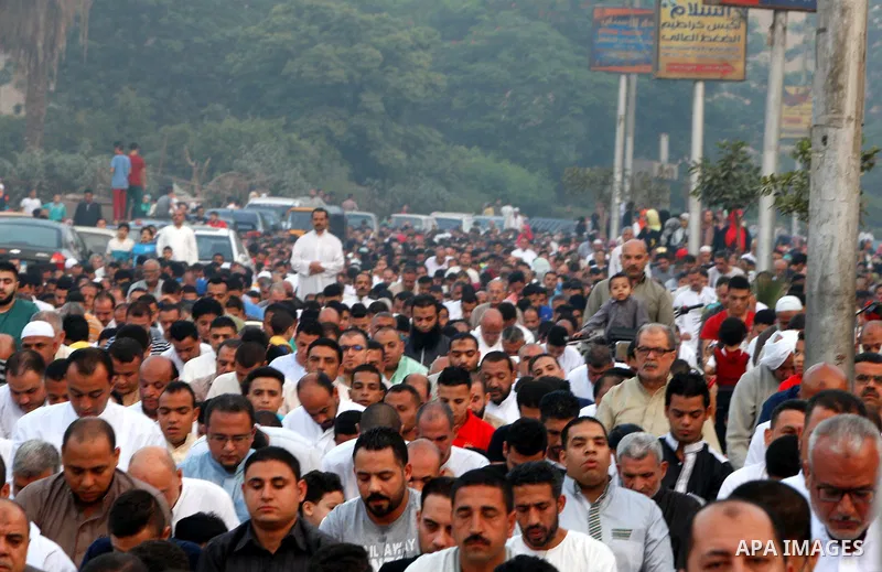 Egyptians attend the morning prayers for Eid al-Fitr celebrations, which marks the end of the holy fasting month of Ramadan, in Cairo, Egypt, on June 25, 2017. Photo by Amr Sayed