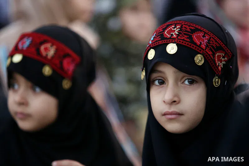 Palestinian Muslim girls attend Eid al-Fitr prayers in Gaza City June 25, 2017. Eid al-Fitr marks the end of Muslim's holy fasting month of Ramadan when faithfuls abstain from eating, drinking, smoking and sexual activit...
