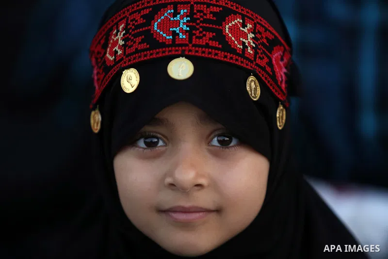 A Palestinian Muslim girl attends Eid al-Fitr prayers in Gaza City June 25, 2017. Eid al-Fitr marks the end of Muslim's holy fasting month of Ramadan when faithfuls abstain from eating, drinking, smoking and sexual activ...