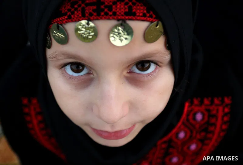 A Palestinian Muslim girl attends Eid al-Fitr prayers in Gaza City June 25, 2017. Eid al-Fitr marks the end of Muslim's holy fasting month of Ramadan when faithfuls abstain from eating, drinking, smoking and sexual activ...