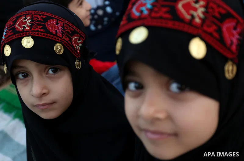 Palestinian Muslim girls attend Eid al-Fitr prayers in Gaza City June 25, 2017. Eid al-Fitr marks the end of Muslim's holy fasting month of Ramadan when faithfuls abstain from eating, drinking, smoking and sexual activit...