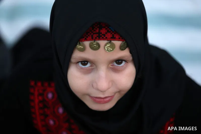 A Palestinian Muslim girl attends Eid al-Fitr prayers in Gaza City June 25, 2017. Eid al-Fitr marks the end of Muslim's holy fasting month of Ramadan when faithfuls abstain from eating, drinking, smoking and sexual activ...