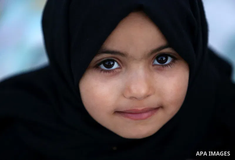 A Palestinian Muslim girl attends Eid al-Fitr prayers in Gaza City June 25, 2017. Eid al-Fitr marks the end of Muslim's holy fasting month of Ramadan when faithfuls abstain from eating, drinking, smoking and sexual activ...