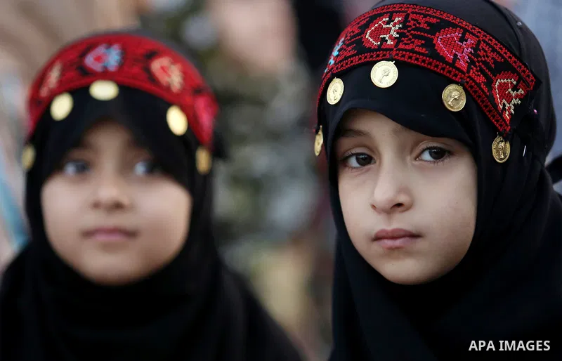 Palestinian Muslim girls attend Eid al-Fitr prayers in Gaza City June 25, 2017. Eid al-Fitr marks the end of Muslim's holy fasting month of Ramadan when faithfuls abstain from eating, drinking, smoking and sexual activit...