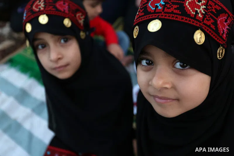 Palestinian Muslim girls attend Eid al-Fitr prayers in Gaza City June 25, 2017. Eid al-Fitr marks the end of Muslim's holy fasting month of Ramadan when faithfuls abstain from eating, drinking, smoking and sexual activit...