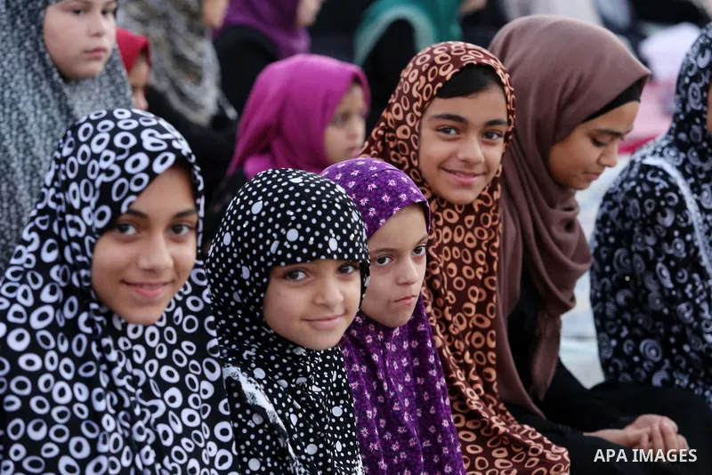 Palestinian Muslim girls attend Eid al-Fitr prayers in Gaza City June 25, 2017. Eid al-Fitr marks the end of Muslim's holy fasting month of Ramadan when faithfuls abstain from eating, drinking, smoking and sexual activit...