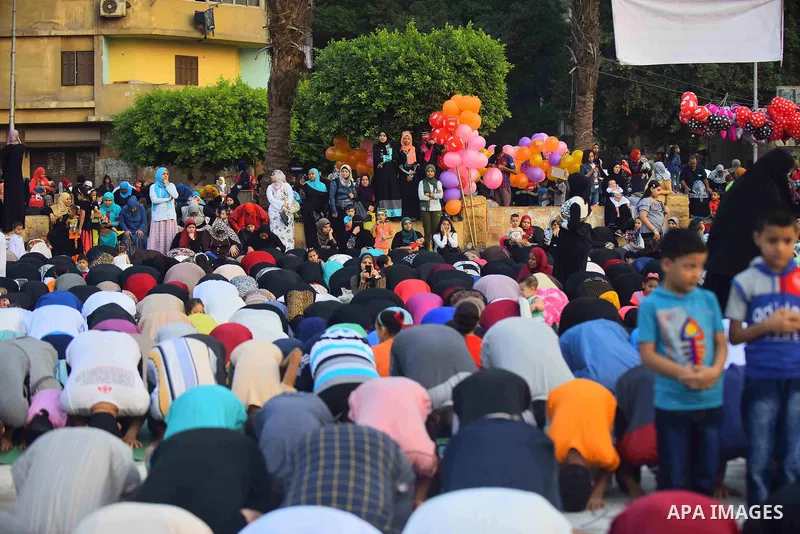 Egyptians attend the morning prayers for Eid al-Fitr celebrations, which marks the end of the holy fasting month of Ramadan, in Cairo, Egypt, on June 25, 2017. Photo by Amr Sayed