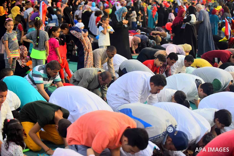 Egyptians attend the morning prayers for Eid al-Fitr celebrations, which marks the end of the holy fasting month of Ramadan, in Cairo, Egypt, on June 25, 2017. Photo by Amr Sayed