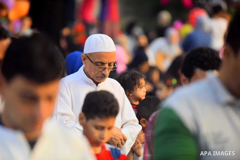 Egyptians attend the morning prayers for Eid al-Fitr celebrations, which marks the end of the holy fasting month of Ramadan, in Cairo, Egypt, on June 25, 2017. Photo by Amr Sayed