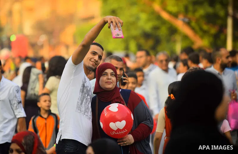 Egyptians take a selfie as they attend the morning prayers for Eid al-Fitr celebrations, which marks the end of the holy fasting month of Ramadan, in Cairo, Egypt, on June 25, 2017. Photo by Amr Sayed
