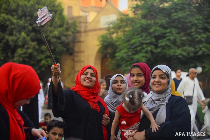 Egyptians take a selfie as they attend the morning prayers for Eid al-Fitr celebrations, which marks the end of the holy fasting month of Ramadan, in Cairo, Egypt, on June 25, 2017. Photo by Amr Sayed