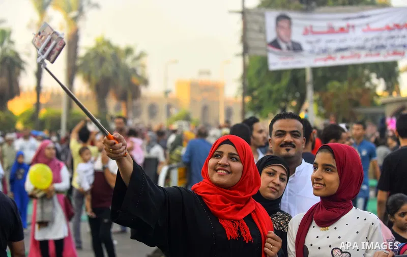 Egyptians take a selfie as they attend the morning prayers for Eid al-Fitr celebrations, which marks the end of the holy fasting month of Ramadan, in Cairo, Egypt, on June 25, 2017. Photo by Amr Sayed