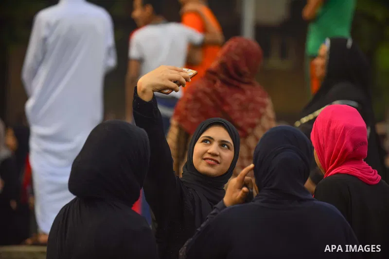 Egyptians take a selfie as they attend the morning prayers for Eid al-Fitr celebrations, which marks the end of the holy fasting month of Ramadan, in Cairo, Egypt, on June 25, 2017. Photo by Amr Sayed