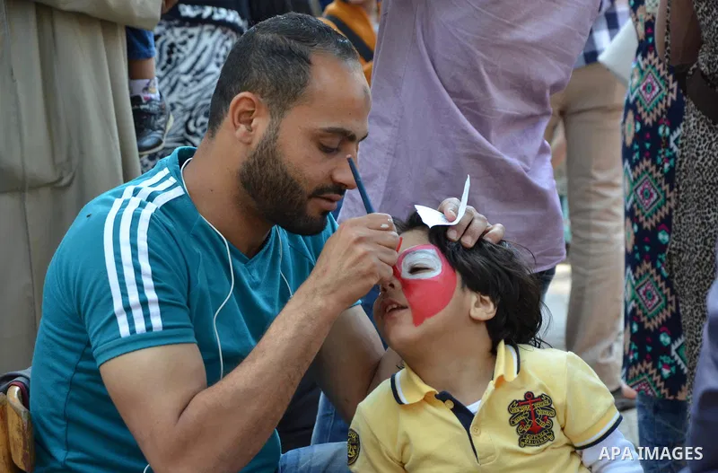 Egyptians celebrate at a park, in Cairo June 25, 2017, on the first day of Eid al-Fitr holiday which marks the end of the Muslim holy month of Ramadan. Photo by Amr Sayed