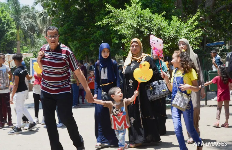 Egyptians celebrate at a park, in Cairo June 25, 2017, on the first day of Eid al-Fitr holiday which marks the end of the Muslim holy month of Ramadan. Photo by Amr Sayed