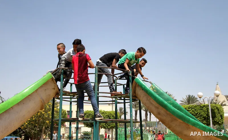 Egyptians celebrate at a park, in Cairo June 26, 2017, on the second day of Eid al-Fitr holiday which marks the end of the Muslim holy month of Ramadan. Photo by Amr Sayed