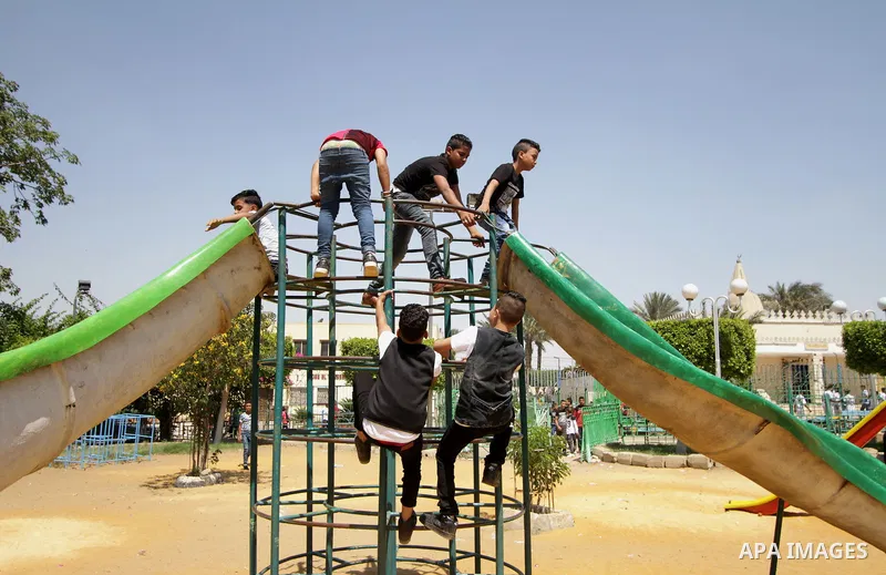Egyptians celebrate at a park, in Cairo June 26, 2017, on the second day of Eid al-Fitr holiday which marks the end of the Muslim holy month of Ramadan. Photo by Amr Sayed