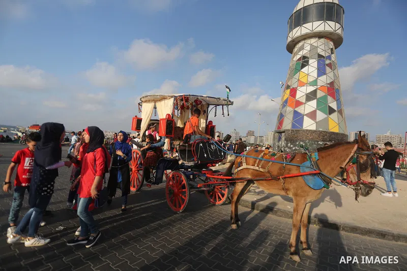 Palestinians celebrate on the second day of Eid al-Fitr holiday which marks the end of the Muslim holy month of Ramadan at the seaport of Gaza city June 26, 2017. Photo by Mohammed Asad
