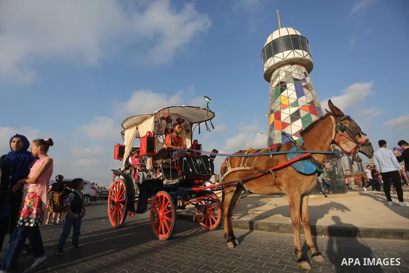 Palestinians celebrate on the second day of Eid al-Fitr holiday which marks the end of the Muslim holy month of Ramadan at the seaport of Gaza city June 26, 2017. Photo by Mohammed Asad