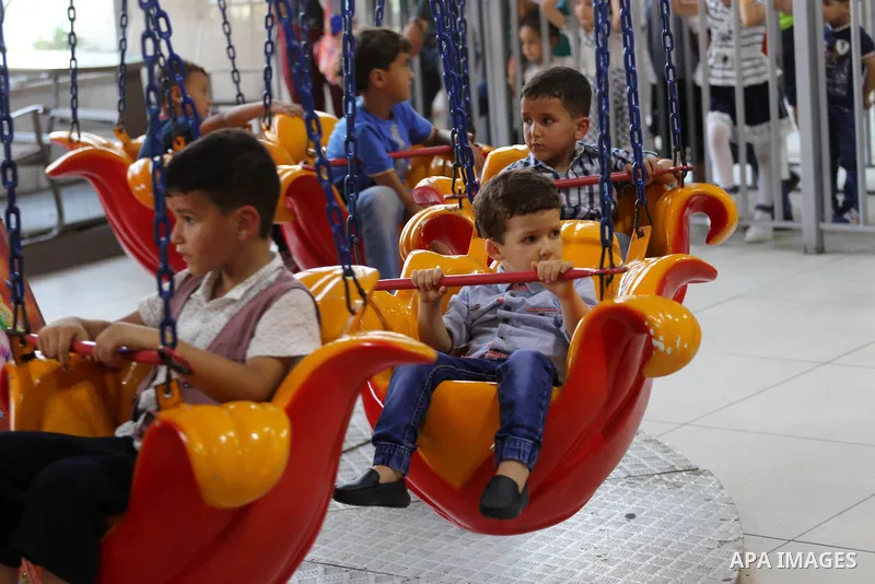 Palestinians celebrate on the second day of Eid al-Fitr holiday which marks the end of the Muslim holy month of Ramadan at the seaport of Gaza city June 26, 2017. Photo by Mohammed Asad