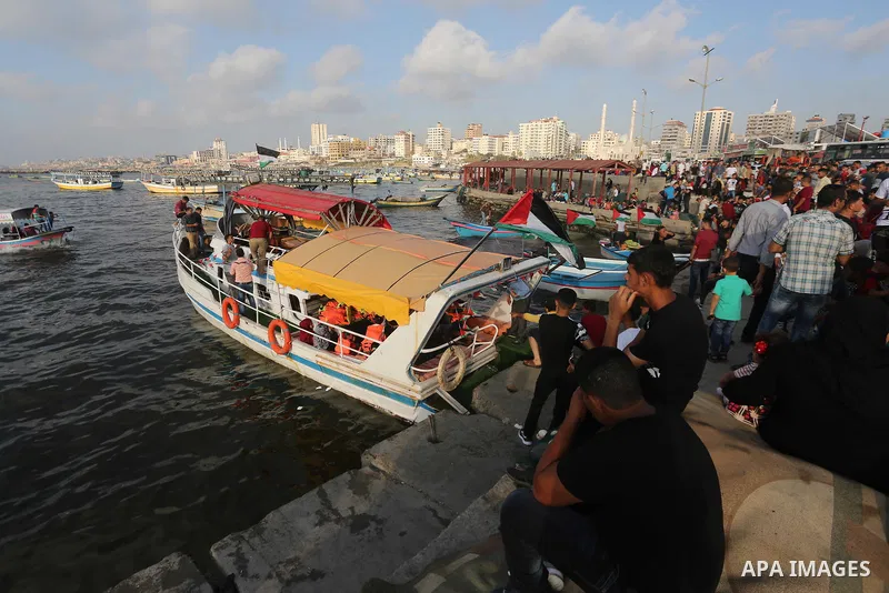 Palestinians celebrate on the second day of Eid al-Fitr holiday which marks the end of the Muslim holy month of Ramadan at the seaport of Gaza city June 26, 2017. Photo by Mohammed Asad