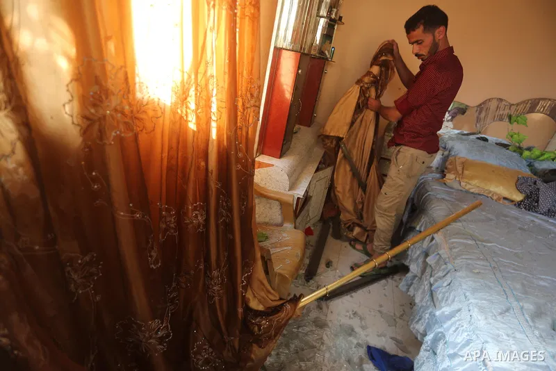 A Palestinian man inspects his home following an Israeli air strike in Gaza City on June 27, 2017. Israeli airstrikes hit a series of targets in the Hamas-run Gaza Strip overnight June 26, officials said, hours after a r...