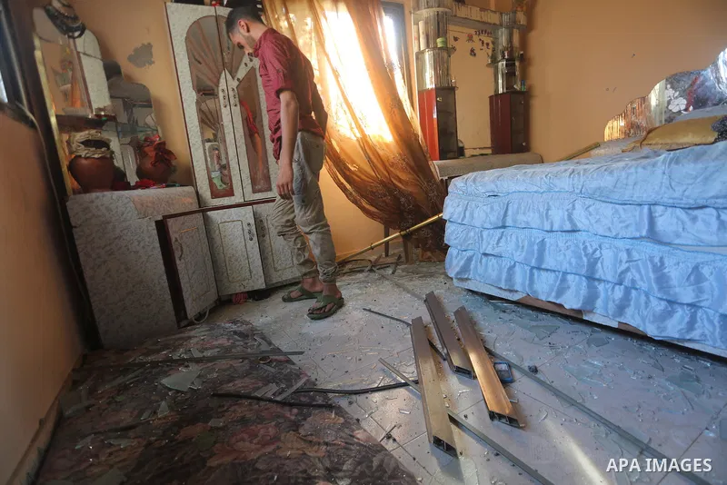 A Palestinian man inspects his home following an Israeli air strike in Gaza City on June 27, 2017. Israeli airstrikes hit a series of targets in the Hamas-run Gaza Strip overnight June 26, officials said, hours after a r...