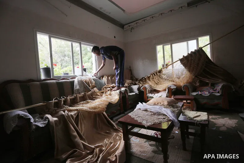 A Palestinian man inspects his home following an Israeli air strike in Gaza City on June 27, 2017. Israeli airstrikes hit a series of targets in the Hamas-run Gaza Strip overnight June 26, officials said, hours after a r...