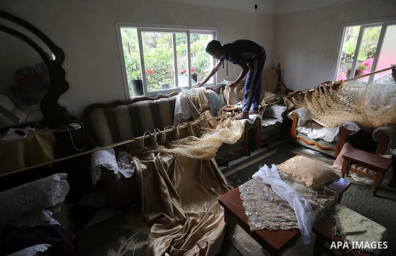 A Palestinian man inspects his home following an Israeli air strike in Gaza City on June 27, 2017. Israeli airstrikes hit a series of targets in the Hamas-run Gaza Strip overnight June 26, officials said, hours after a r...