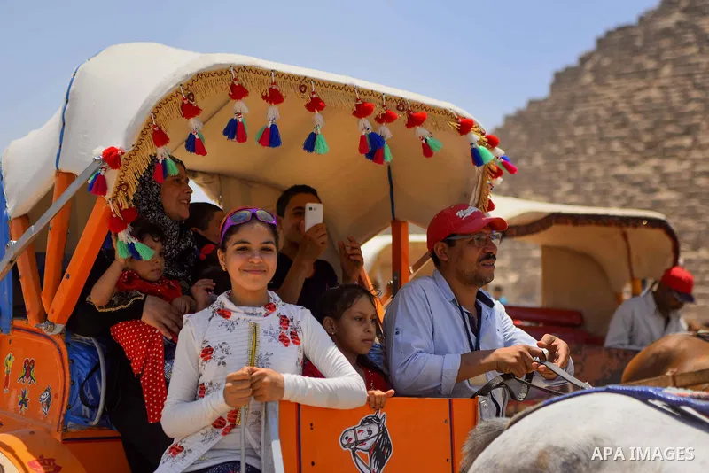 Egyptians ride horse carts in front of the Giza pyramids, on the third day of Eid al-Fitr holiday which marks the end of the Muslim holy month of Ramadan, in Cairo June 27, 2017. Photo by Amr Sayed