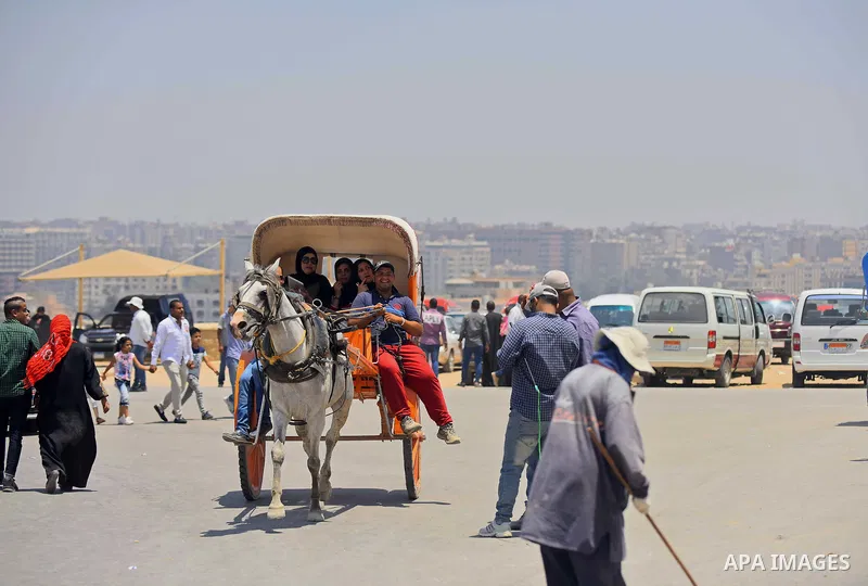Egyptians ride horse carts in front of the Giza pyramids, on the third day of Eid al-Fitr holiday which marks the end of the Muslim holy month of Ramadan, in Cairo June 27, 2017. Photo by Amr Sayed