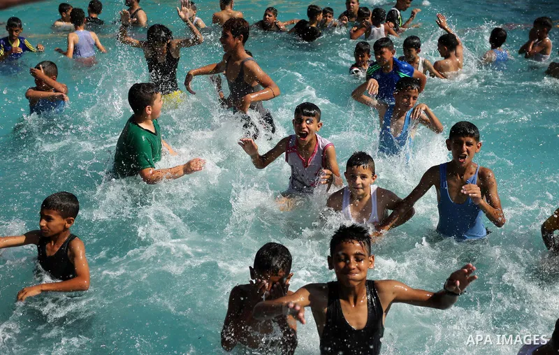 Palestinian children swim in a pool at an amusement park on the third day of Eid al-Fitr holiday which marks the end of the Muslim holy month of Ramadan, in Gaza City on June 27, 2017. Photo by Ashraf Amra