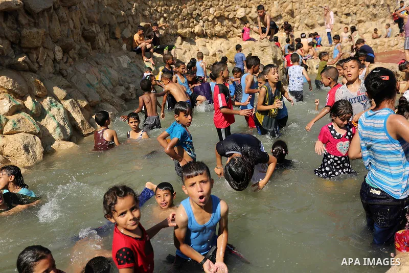Palestinian children swim in a pool at an amusement park on the third day of Eid al-Fitr holiday which marks the end of the Muslim holy month of Ramadan, in Gaza City on June 27, 2017. Photo by Ashraf Amra