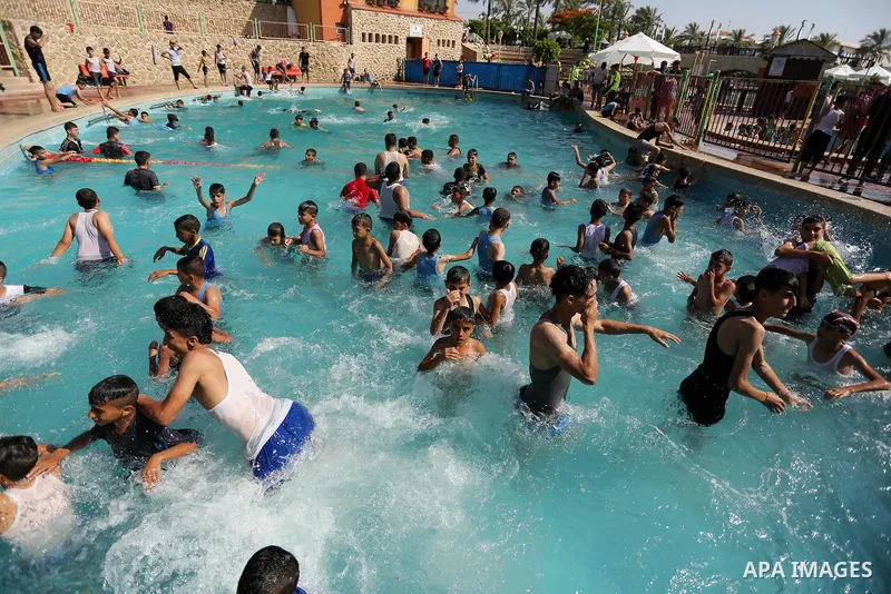 Palestinian children swim in a pool at an amusement park on the third day of Eid al-Fitr holiday which marks the end of the Muslim holy month of Ramadan, in Gaza City on June 27, 2017. Photo by Ashraf Amra