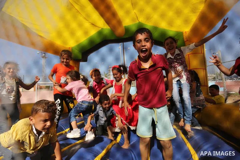Palestinian children play at an amusement park on the third day of Eid al-Fitr holiday which marks the end of the Muslim holy month of Ramadan, in Gaza City on June 27, 2017. Photo by Ashraf Amra