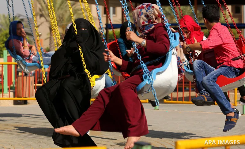 Palestinians take a ride at an amusement park on the third day of Eid al-Fitr holiday which marks the end of the Muslim holy month of Ramadan, in Gaza City on June 27, 2017. Photo by Ashraf Amra