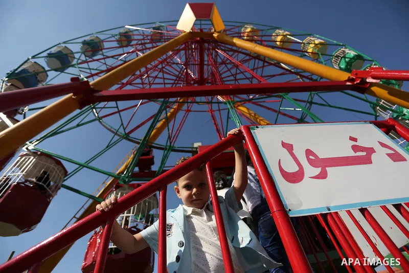 Palestinian children play at an amusement park on the third day of Eid al-Fitr holiday which marks the end of the Muslim holy month of Ramadan, in Gaza City on June 27, 2017. Photo by Ashraf Amra
