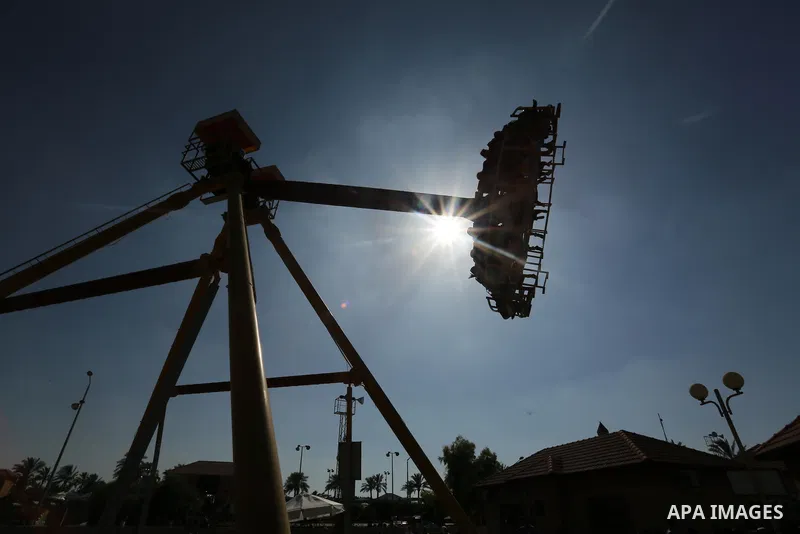 Palestinians take a ride at an amusement park on the third day of Eid al-Fitr holiday which marks the end of the Muslim holy month of Ramadan, in Gaza City on June 27, 2017. Photo by Ashraf Amra