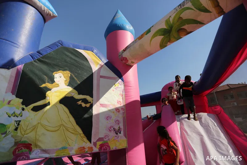 Palestinian children play at an amusement park on the third day of Eid al-Fitr holiday which marks the end of the Muslim holy month of Ramadan, in Gaza City on June 27, 2017. Photo by Ashraf Amra
